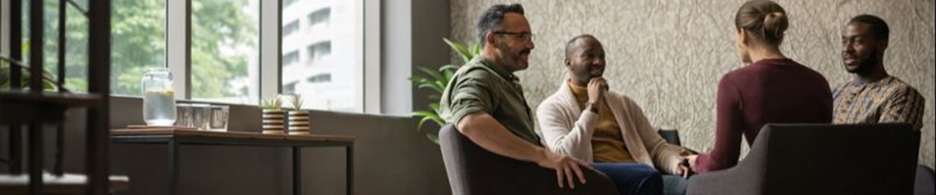 Small business IT professionals meeting with clients in a modern, open office setting